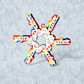colorful snowflake ornament made of the word 'skater' in white on a rainbow background